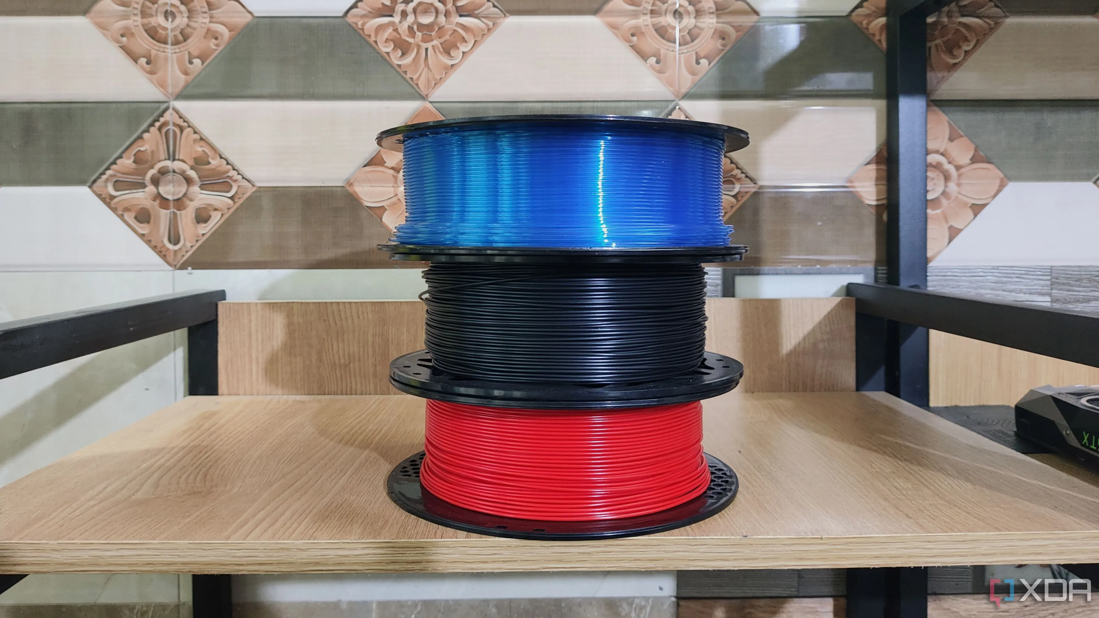 Ba cuộn nhựa filament màu sắc khác nhau đang được sử dụng cho máy in 3D