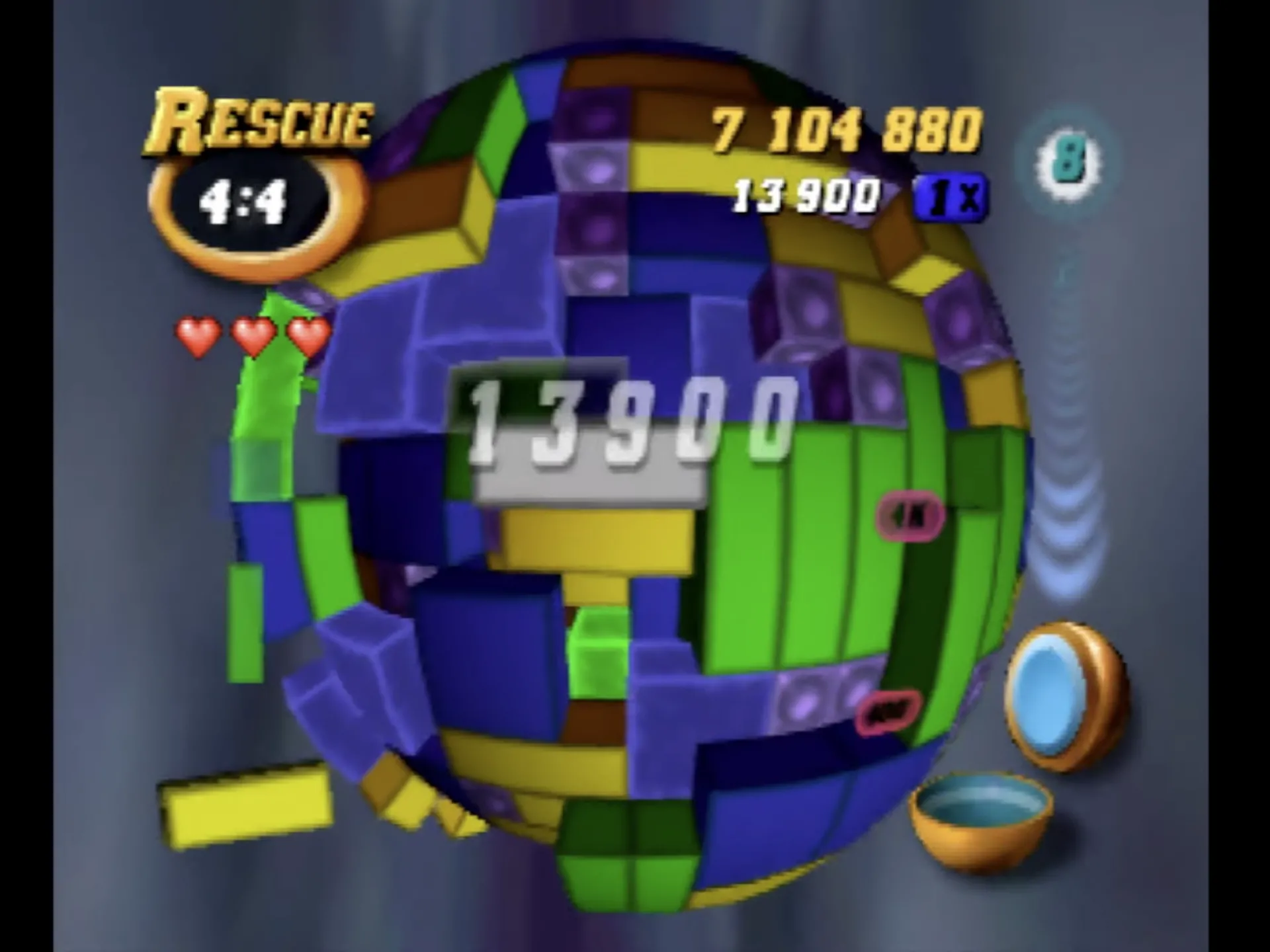 Giao diện game Tetrisphere trên Nintendo 64, hiển thị các khối 3D đầy màu sắc đang được ghép nối để phá hủy và tiến vào lõi