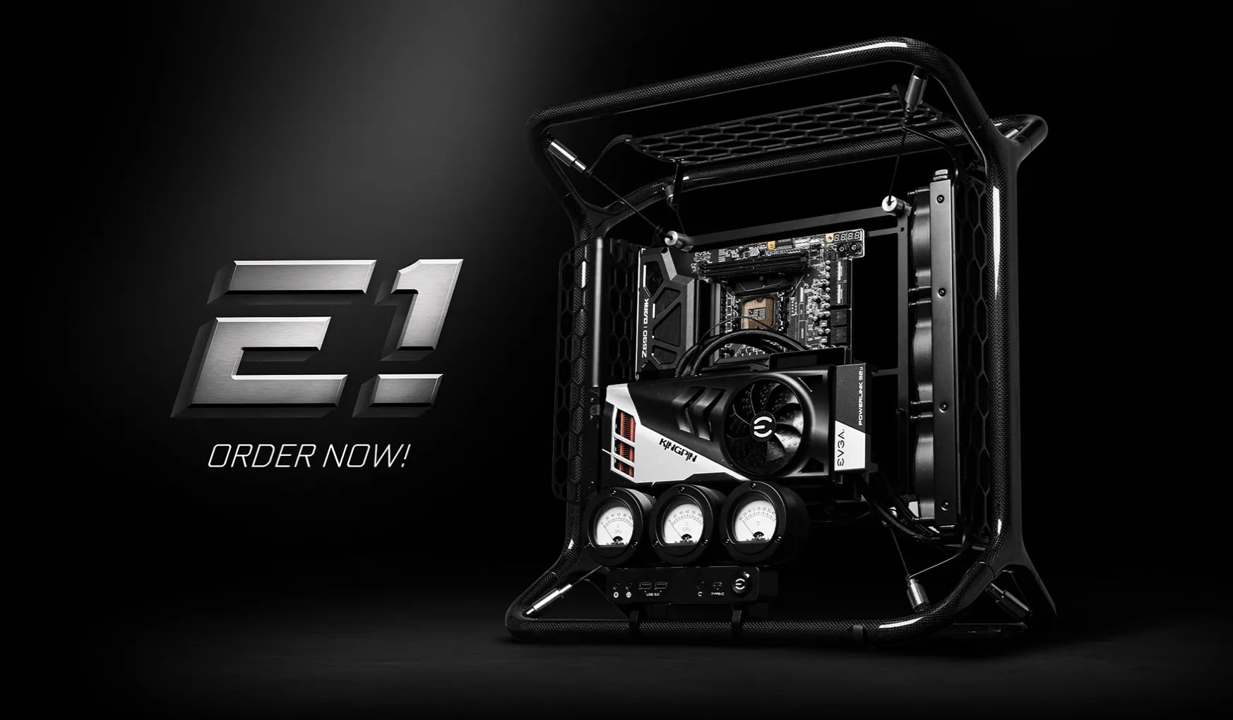Khung máy tính EVGA E1 với thiết kế mở, mainboard treo và đồng hồ đo analog