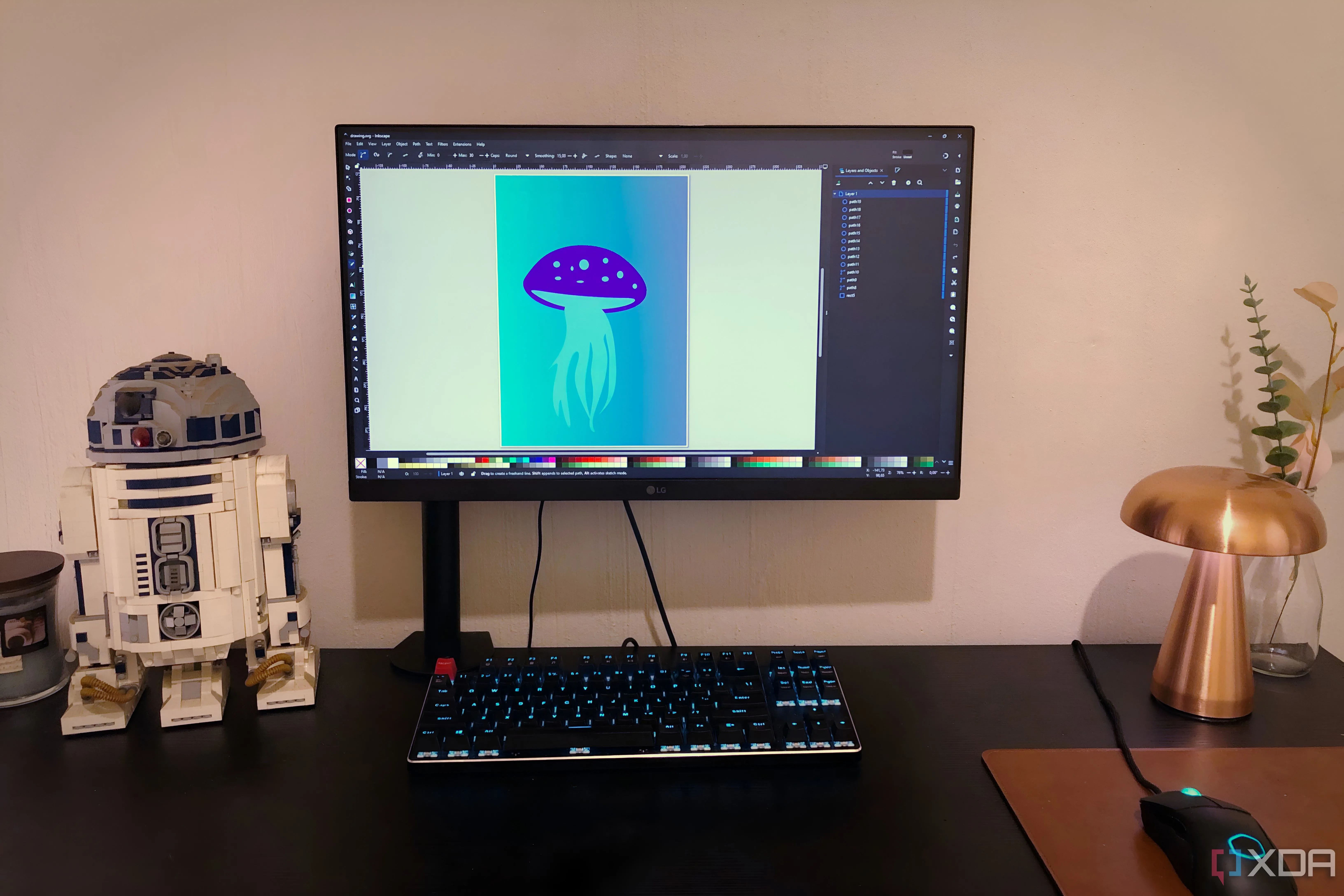 Minh họa sứa trong Inkscape hiển thị trên máy tính để bàn, cùng với đồ chơi Lego, đèn và cây cảnh