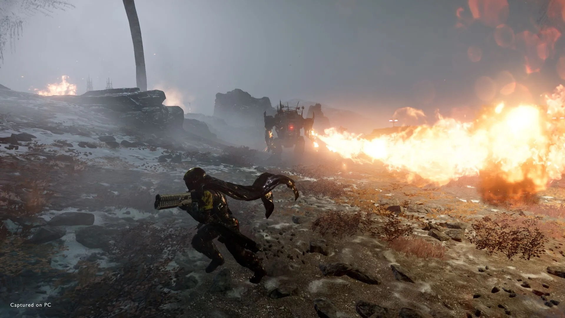 Một bộ mech mạnh mẽ từ Helldivers 2 đang phun lửa, tiêu diệt kẻ thù trên chiến trường
