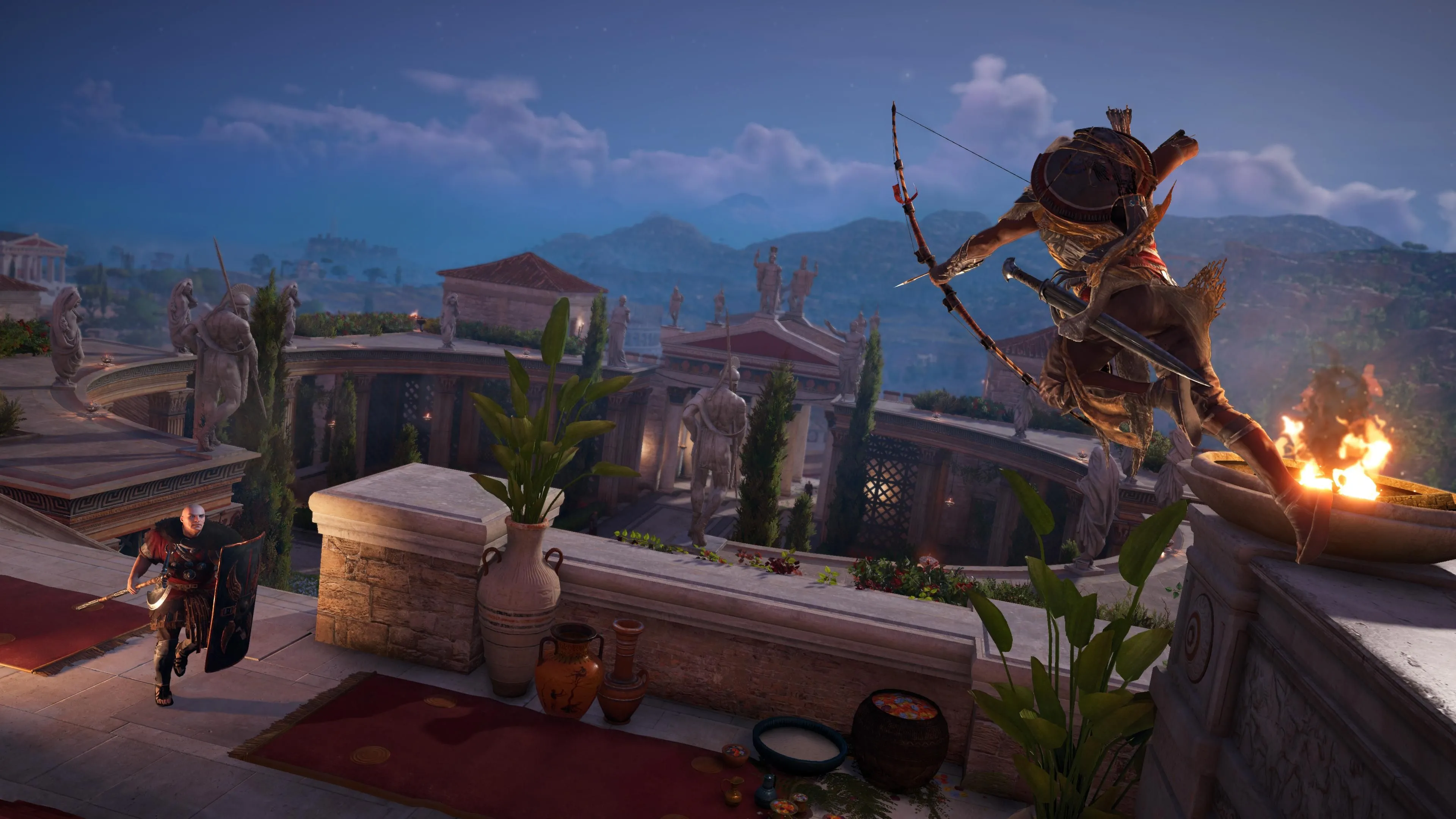 Nhân vật Bayek nhảy từ vách đá và nhắm cung vào lính canh trong Assassin's Creed Origins, tái hiện Ai Cập cổ đại